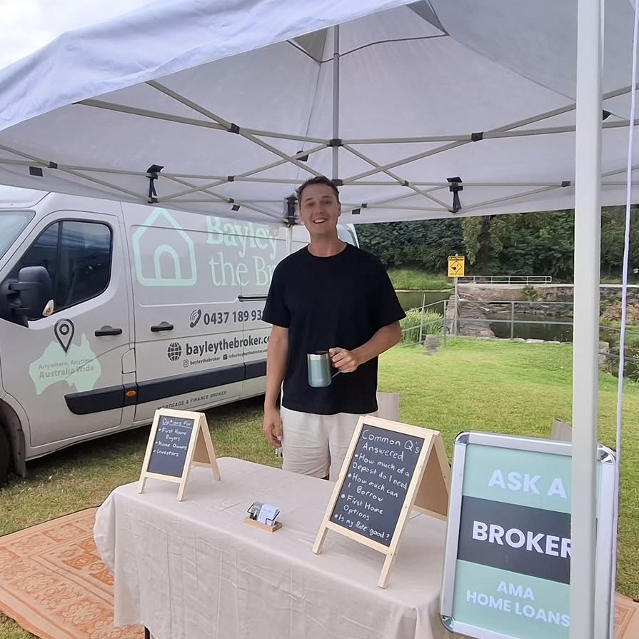 Bayley Clarke running a free Ask a Broker stall at a local market